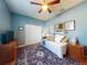 This bedroom features a ceiling fan, decorative rug, dresser, and ample natural light at 9172 Se 130Th Loop, Summerfield, FL 34491
