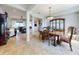 Spacious dining room with tile floors, traditional-style furniture and decor and direct access to the living room at 9172 Se 130Th Loop, Summerfield, FL 34491