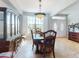 Elegant dining room showcasing window with shutters, stylish furniture, and entryway at 9172 Se 130Th Loop, Summerfield, FL 34491