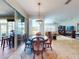 Dining room with traditional furnishings and view to the living room through large sliding glass doors at 9172 Se 130Th Loop, Summerfield, FL 34491
