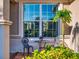 Close-up of a window with outdoor seating and decorative plants in a lovely setting at 9172 Se 130Th Loop, Summerfield, FL 34491