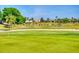 Scenic golf course view with lush green fairways, palm trees, and beautiful homes in the background at 9172 Se 130Th Loop, Summerfield, FL 34491