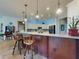 Beautiful kitchen with a large island, pendant lighting, stainless steel appliances, and tile flooring at 9172 Se 130Th Loop, Summerfield, FL 34491