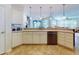 Bright kitchen featuring an island with bar seating, stainless steel appliances, and modern sink at 9172 Se 130Th Loop, Summerfield, FL 34491