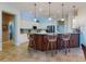 Spacious kitchen with an island, pendant lights, white cabinets, and stainless steel appliances at 9172 Se 130Th Loop, Summerfield, FL 34491
