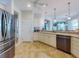Bright kitchen featuring an island with bar seating, stainless steel appliances, and access to the porch at 9172 Se 130Th Loop, Summerfield, FL 34491