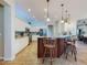 Bright kitchen featuring an island with bar seating, stainless steel appliances, and pendant lighting at 9172 Se 130Th Loop, Summerfield, FL 34491