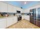 Bright kitchen with stainless steel appliances, tile backsplash, and ample counter space at 9172 Se 130Th Loop, Summerfield, FL 34491