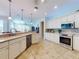 Bright kitchen with stainless steel appliances, tile backsplash, and access to the living room at 9172 Se 130Th Loop, Summerfield, FL 34491