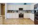 Bright kitchen with stainless steel appliances, tile backsplash, and ample counter space at 9172 Se 130Th Loop, Summerfield, FL 34491