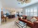 Open-concept living room with tile floors, comfortable seating, views into the kitchen and dining areas at 9172 Se 130Th Loop, Summerfield, FL 34491