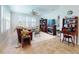 Bright living room with a ceiling fan, tile flooring, shutters, and cozy furniture at 9172 Se 130Th Loop, Summerfield, FL 34491
