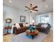 Cozy living room with neutral decor, two sofas, a ceiling fan, and large sliding doors at 9172 Se 130Th Loop, Summerfield, FL 34491