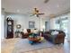Inviting living room with comfortable seating, ceiling fan, and a warm, welcoming atmosphere at 9172 Se 130Th Loop, Summerfield, FL 34491