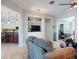 Cozy living room with built-in shelving and open floor plan leading to the kitchen and dining area at 9172 Se 130Th Loop, Summerfield, FL 34491