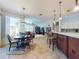 Open concept living space with dining table, kitchen counter seating, and view to living room at 9172 Se 130Th Loop, Summerfield, FL 34491