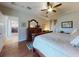 Relaxing main bedroom features hard wood floors and a doorway that leads to the kitchen at 9172 Se 130Th Loop, Summerfield, FL 34491
