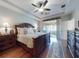 An expansive main bedroom with a ceiling fan and sliding glass doors to an outdoor area at 9172 Se 130Th Loop, Summerfield, FL 34491