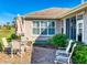 This brick patio has seating and views of the garden, plants, and nearby golf course at 9172 Se 130Th Loop, Summerfield, FL 34491