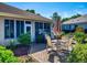 Outdoor patio area with brick pavers, dining set, and views of the beautifully landscaped yard at 9172 Se 130Th Loop, Summerfield, FL 34491