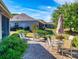 Cozy outdoor patio with brick pavers, lounge and dining seating, amid lush landscaping at 9172 Se 130Th Loop, Summerfield, FL 34491