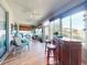 Bright sunroom with a bar, ceiling fans, lots of windows, and a view of the backyard at 9172 Se 130Th Loop, Summerfield, FL 34491