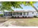 Spacious backyard featuring a screened lanai, mature trees and manicured landscaping at 9741 Sw 97Th Ln, Ocala, FL 34481
