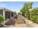 Backyard featuring a screened-in patio with a small decorative fence and surrounding greenery at 9741 Sw 97Th Ln, Ocala, FL 34481