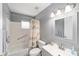 Well-lit bathroom with shower and tub combination, and a large mirror at 9741 Sw 97Th Ln, Ocala, FL 34481