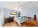 Bright bedroom with wood floors and a large window offering plenty of natural light at 9741 Sw 97Th Ln, Ocala, FL 34481