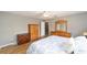 This bedroom has wood floors, a ceiling fan, and includes a dresser with mirror at 9741 Sw 97Th Ln, Ocala, FL 34481