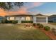 Charming home featuring a well-manicured lawn, tidy landscaping, and an inviting facade at 9741 Sw 97Th Ln, Ocala, FL 34481