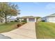 A well-kept, single-story home with nice landscaping and a long concrete driveway at 9741 Sw 97Th Ln, Ocala, FL 34481
