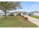 Single story home featuring a well manicured lawn and tidy landscaping at 9741 Sw 97Th Ln, Ocala, FL 34481