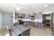 Updated kitchen with stainless steel appliances, gray cabinets, and an adjacent dining space at 9741 Sw 97Th Ln, Ocala, FL 34481
