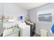 Functional laundry room with washer, dryer, and utility sink, ready for your convenience at 9741 Sw 97Th Ln, Ocala, FL 34481