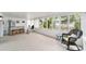 Inviting sunroom with ample natural light, wicker chair, and exercise equipment overlooking the backyard at 9741 Sw 97Th Ln, Ocala, FL 34481