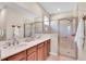 Bathroom features a double vanity, walk-in shower, and neutral toned walls at 9856 Sw 100Th Ter, Ocala, FL 34481