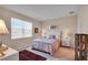 Bright bedroom features neutral walls, carpet floors, a window and is styled with lamps and decor at 9856 Sw 100Th Ter, Ocala, FL 34481