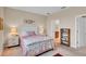 Carpeted bedroom with a white bed set and neutral walls, styled with lamps at 9856 Sw 100Th Ter, Ocala, FL 34481