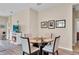 Dining area with round glass table, seating for four, and a view of living room at 9856 Sw 100Th Ter, Ocala, FL 34481