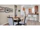 Dining area with round glass table, seating for four, and a breakfast bar at 9856 Sw 100Th Ter, Ocala, FL 34481