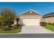 Lovely single-story home featuring a two-car garage, red front door, and a well-kept lawn with pretty landscaping at 9856 Sw 100Th Ter, Ocala, FL 34481