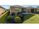 Charming home exterior with well-manicured landscaping and a screened lanai, perfect for outdoor enjoyment at 9856 Sw 100Th Ter, Ocala, FL 34481