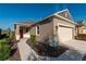 Inviting single-story home showcasing a two-car garage, red front door, and a neatly landscaped front yard at 9856 Sw 100Th Ter, Ocala, FL 34481