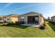 Well-maintained home exterior with lush green lawn, manicured bushes, and a screened lanai for outdoor relaxation at 9856 Sw 100Th Ter, Ocala, FL 34481