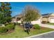 Well-kept single-story home with a two-car garage, lush landscaping, and a charming mailbox in the front yard at 9856 Sw 100Th Ter, Ocala, FL 34481