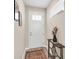 Bright foyer featuring a white front door with glass panels, a small accent table, and stylish decor at 9856 Sw 100Th Ter, Ocala, FL 34481