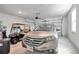 Garage with car, golf cart, and epoxy flooring at 9856 Sw 100Th Ter, Ocala, FL 34481