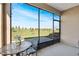 Inviting screened-in lanai offers a peaceful retreat with views of the expansive lawn and distant trees at 9856 Sw 100Th Ter, Ocala, FL 34481